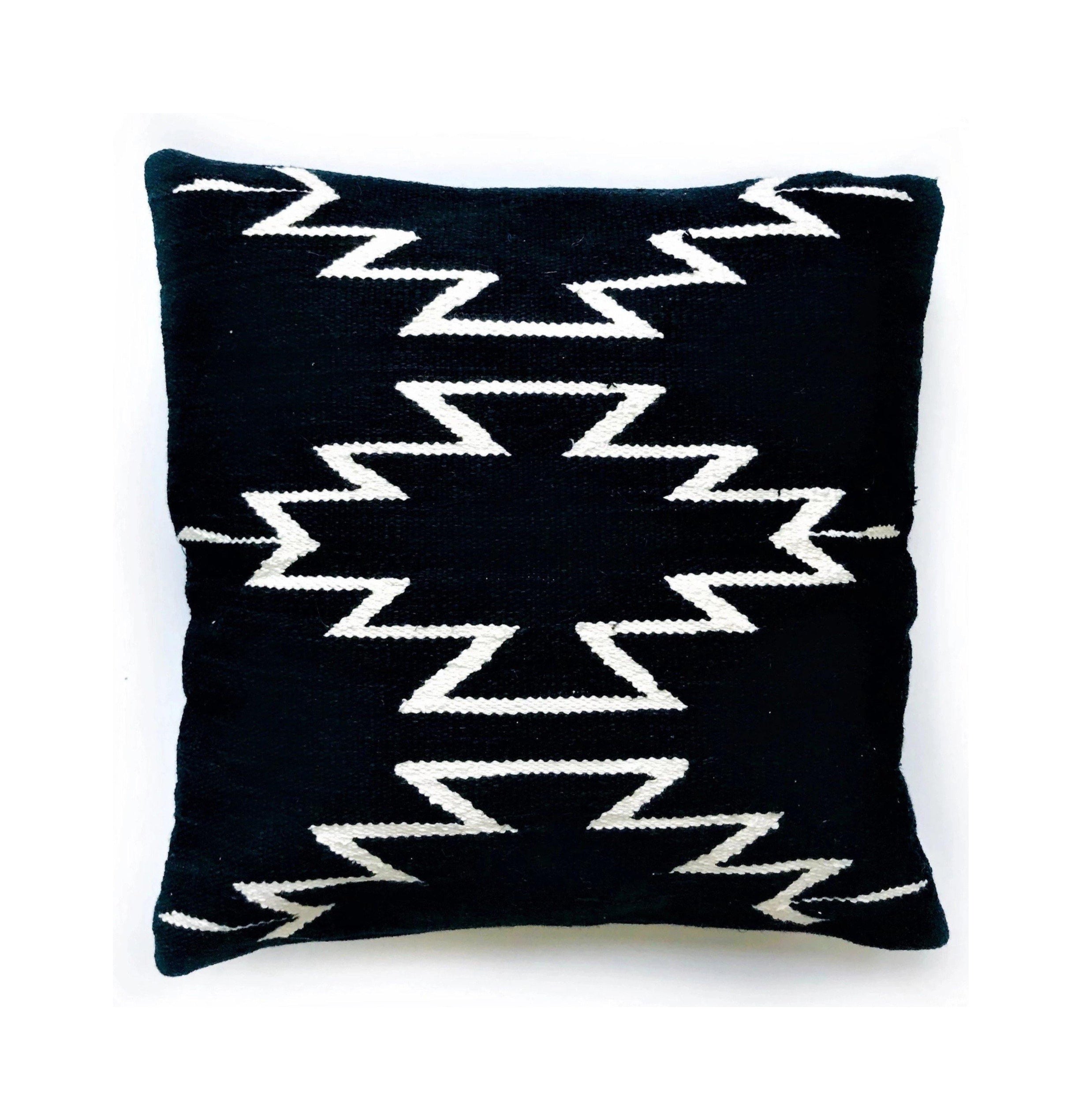 Black pillow with white zigzag pattern on a white background