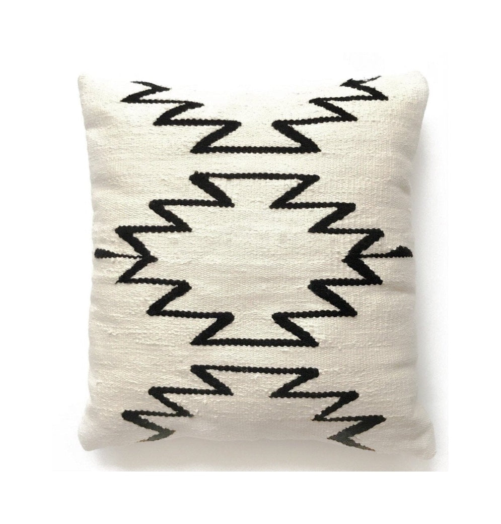 Decorative pillow with black zigzag pattern on a white background