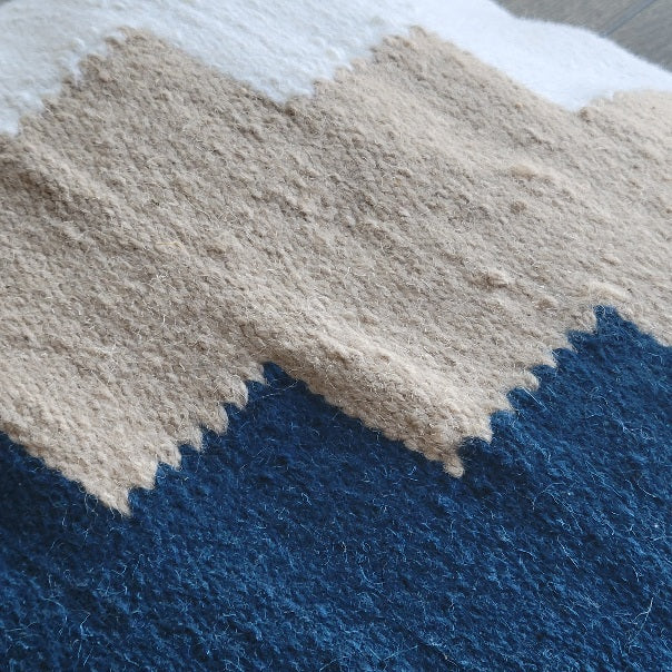 Close-up of Kaira navy and mustard throw pillow showcasing premium wool fabric and elegant zigzag design.