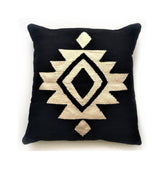 Black pillow with a geometric pattern on a white background