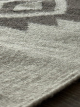 Close-up of a textured surface with a logo or brand name partially visible.