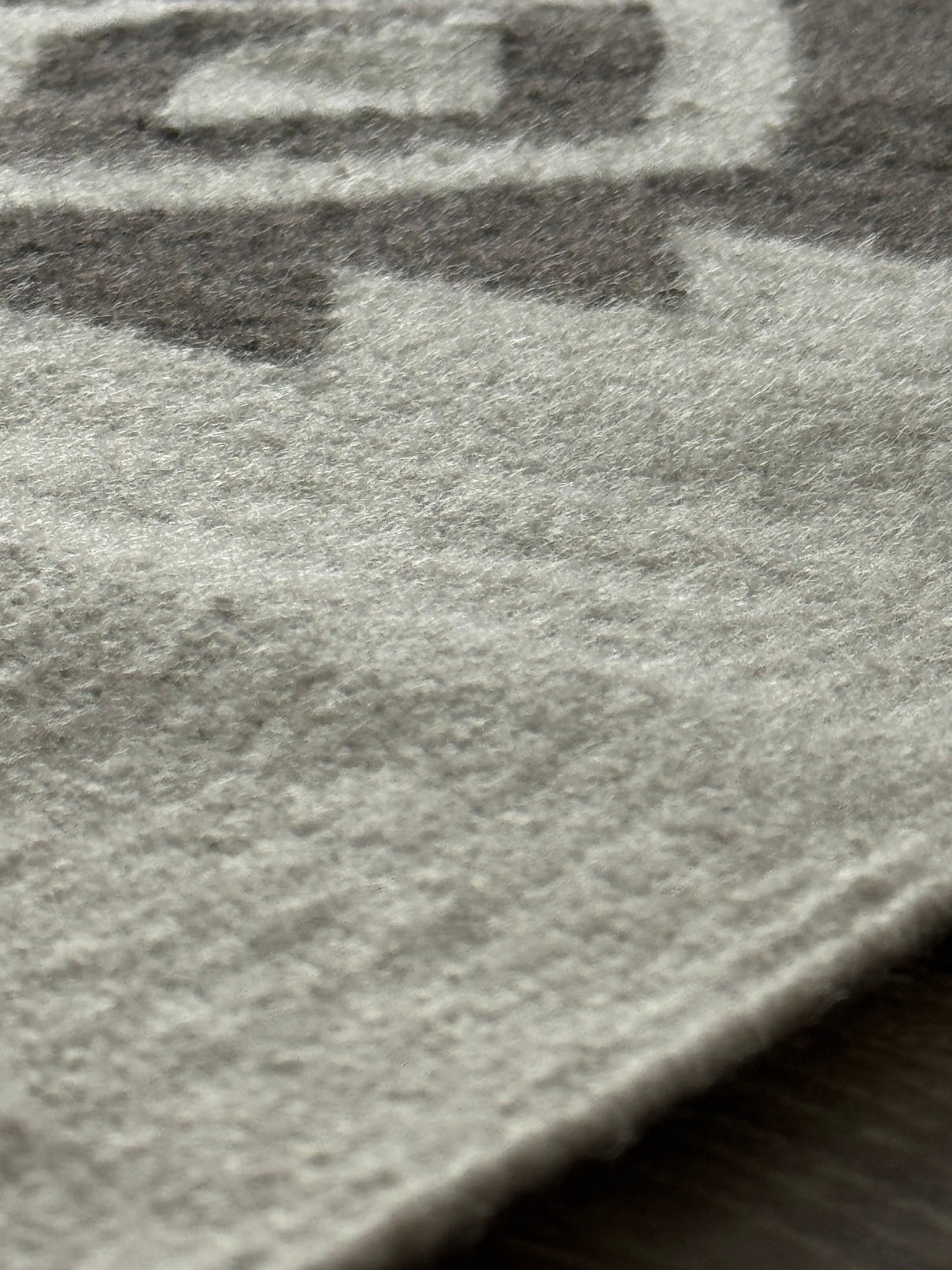 Close-up of a textured surface with a logo or brand name partially visible.