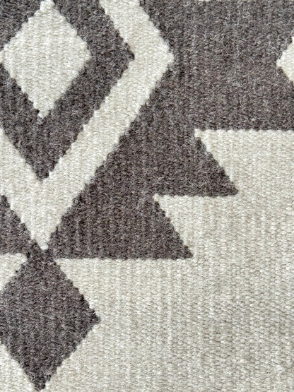 Close-up of a textured rug with geometric pattern
