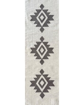 Rug with black geometric pattern on a light gray background