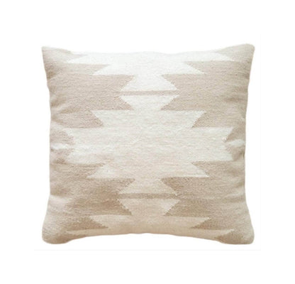 Beige and white patterned pillow on a white background
