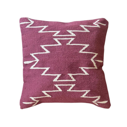 Mulberry pillow with white zigzag pattern on a white background