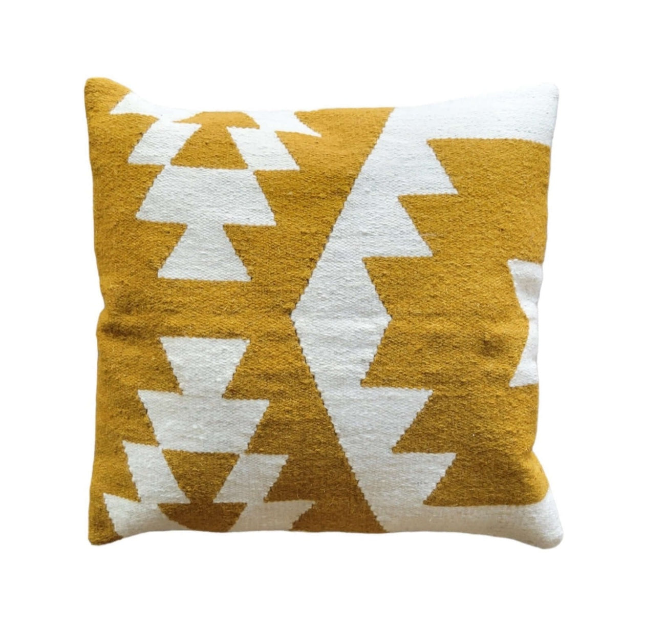 Yellow and white geometric patterned pillow on a white background