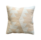 Decorative pillow with geometric pattern on a Nude Beige