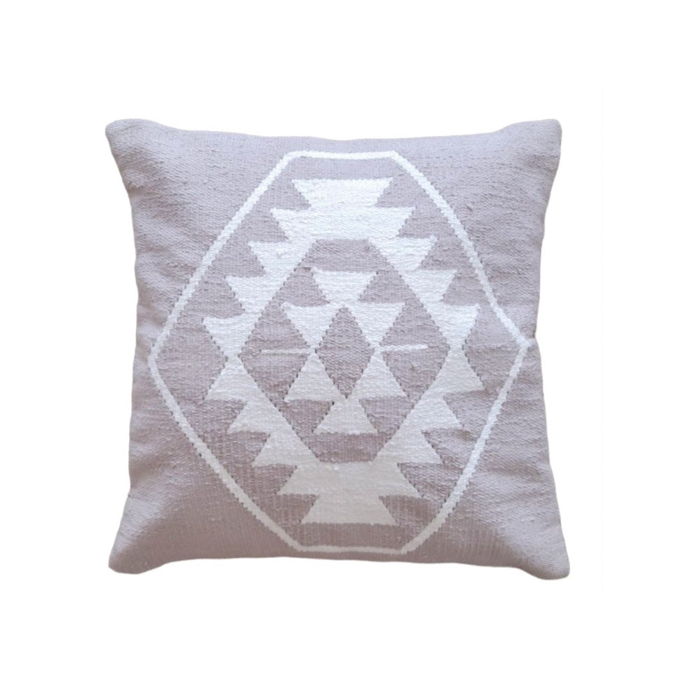 Taupe pillow with white geometric pattern on a white background