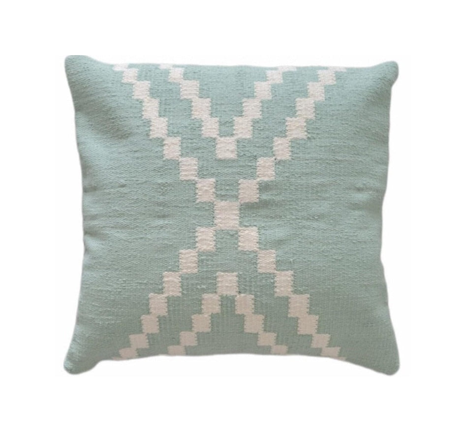 Decorative pillow with geometric pattern on a light green background