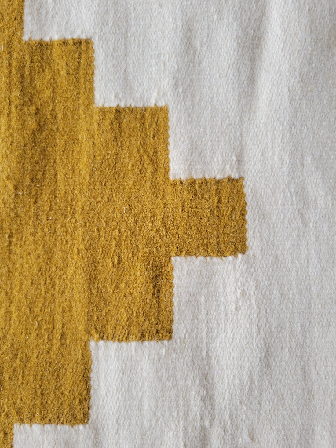 cream wool rug with tassels