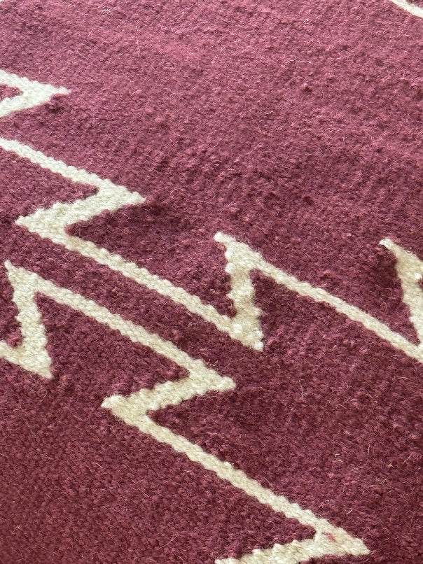 Close-up of a textured Mulberry pillow with white zigzag pattern