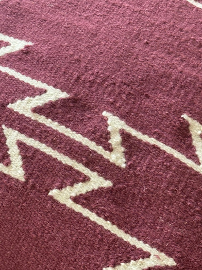 Close-up of a textured Mulberry pillow with white zigzag pattern