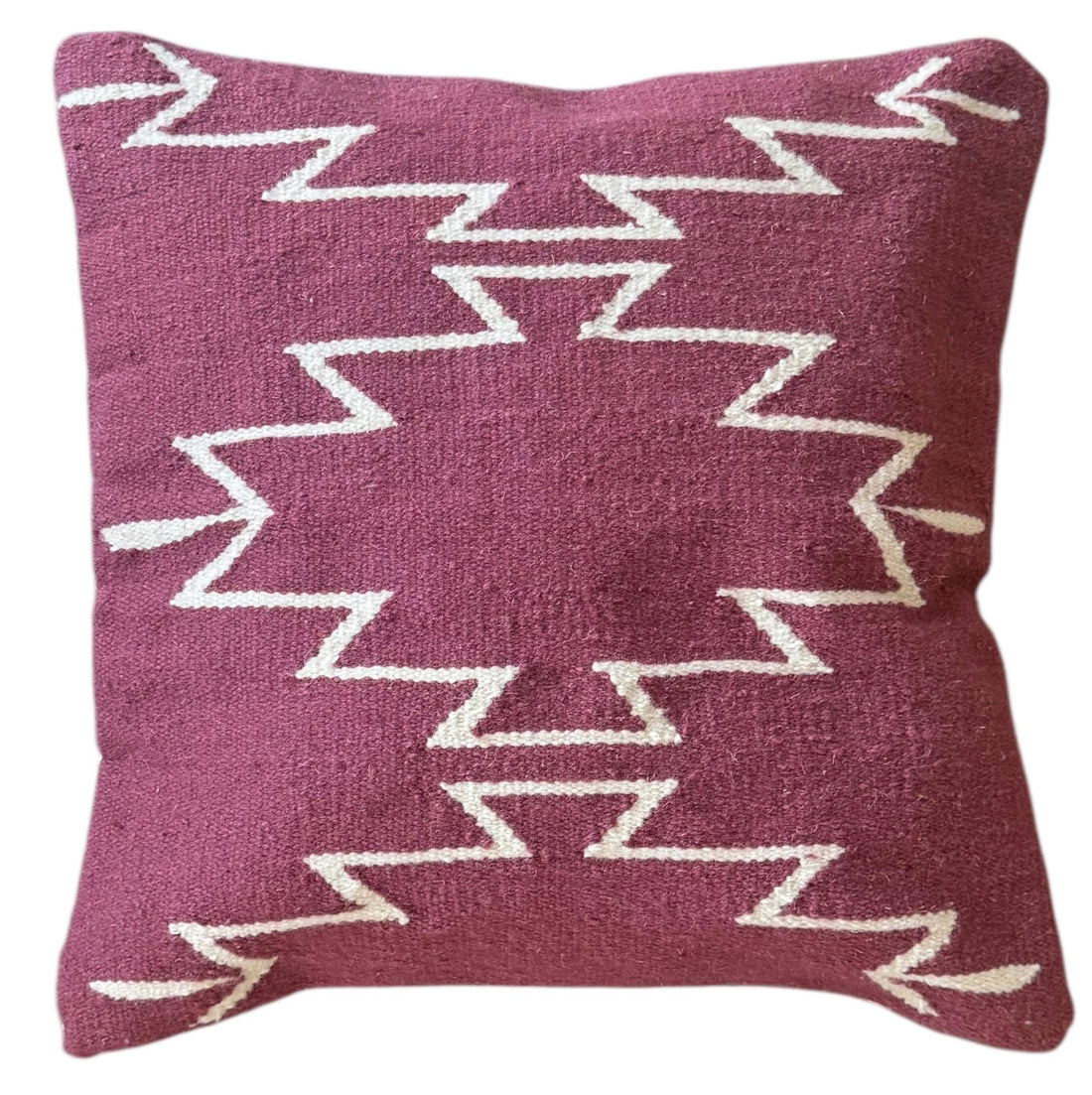 Decorative pillow with zigzag pattern on a white background