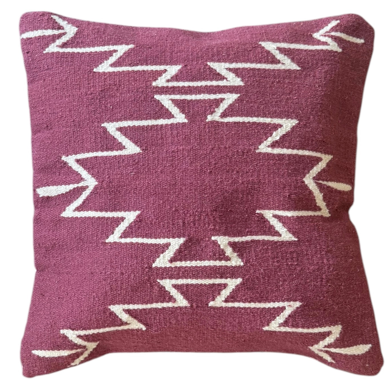 Decorative pillow with zigzag pattern on a white background