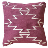 Decorative pillow with zigzag pattern on a white background