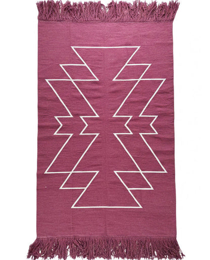Deep wine rug with white geometric pattern and fringes on a white background