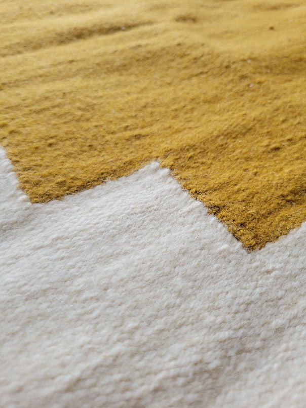 cream handmade rug with tassels