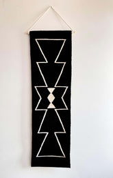 Black handwoven wall hanging rug tapestry with geometric white patterns