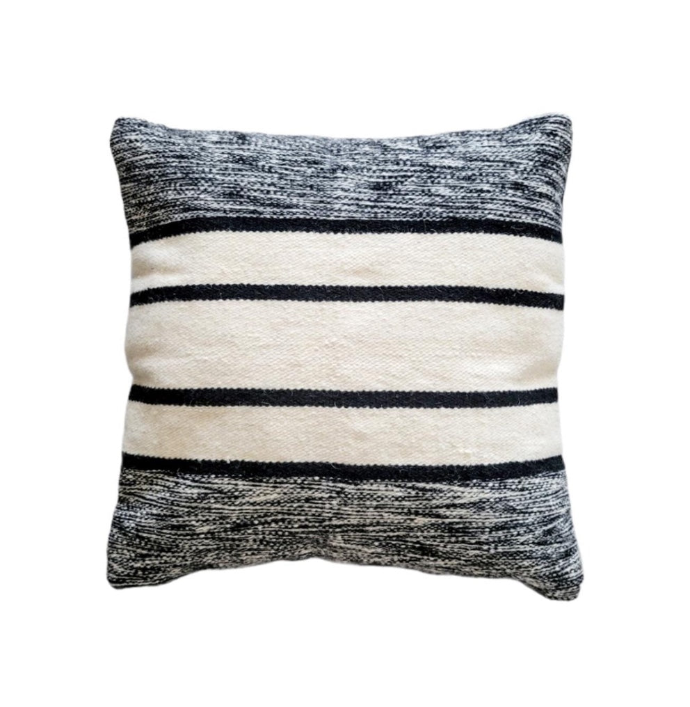 Striped pillow with black and white pattern on a white background