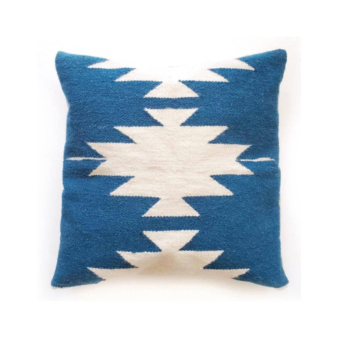 Blue and white patterned pillow on a white background