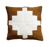 Brown and white geometric patterned pillow on a white background