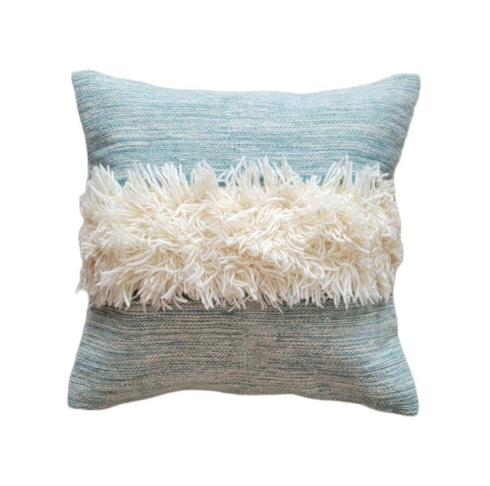 Decorative pillow with blue and gray striped pattern and white fluffy top