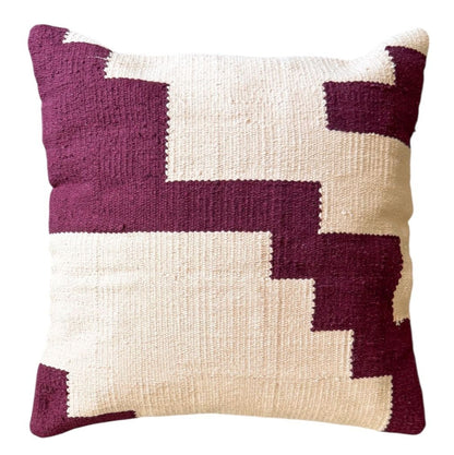 Decorative pillow with geometric pattern in purple and pink 