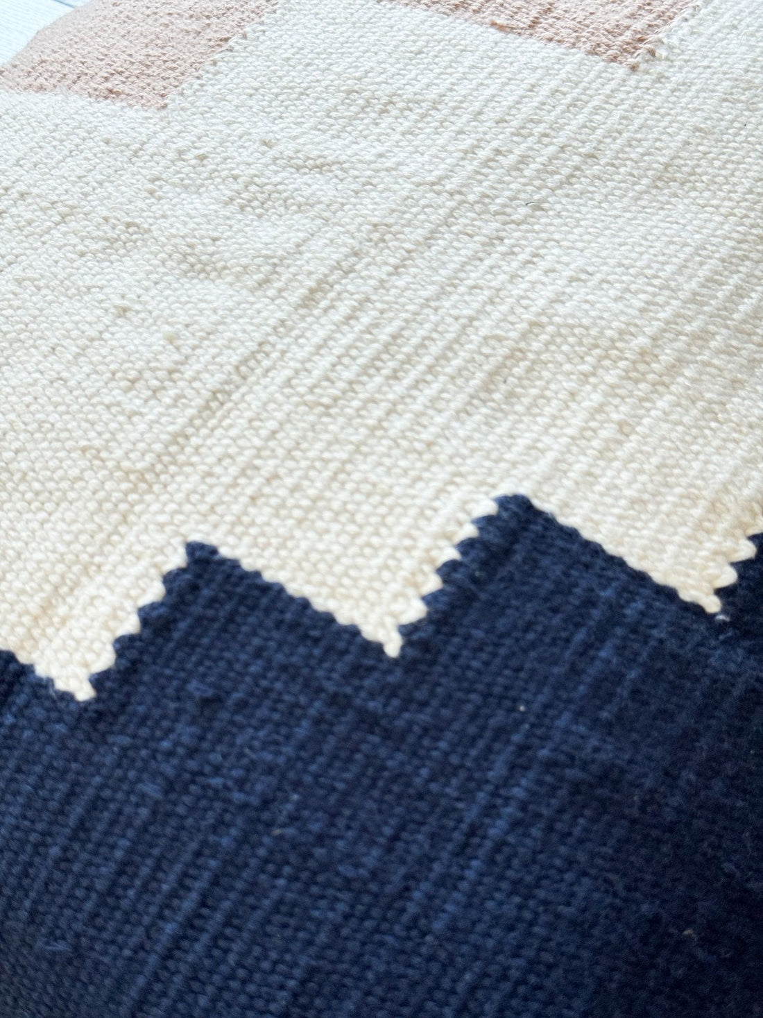 Close-up of a textured fabric with blue, white, and pink colors.