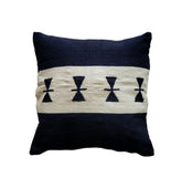 Decorative pillow with black and white pattern on a beige background