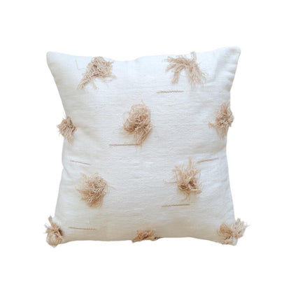 Decorative pillow with tassel patterns on a white background