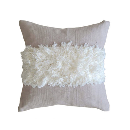 Decorative pillow with white fluffy top and taupe back on a white background