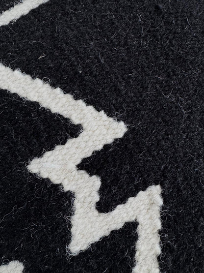 Close-up of a black fabric with white geometric patterns