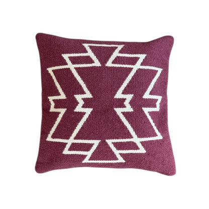 Maroon pillow with white geometric pattern on a Maroon background