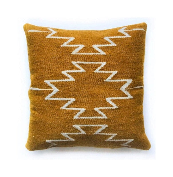 Brown pillow with white zigzag pattern