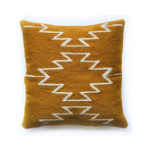 Brown pillow with white zigzag pattern