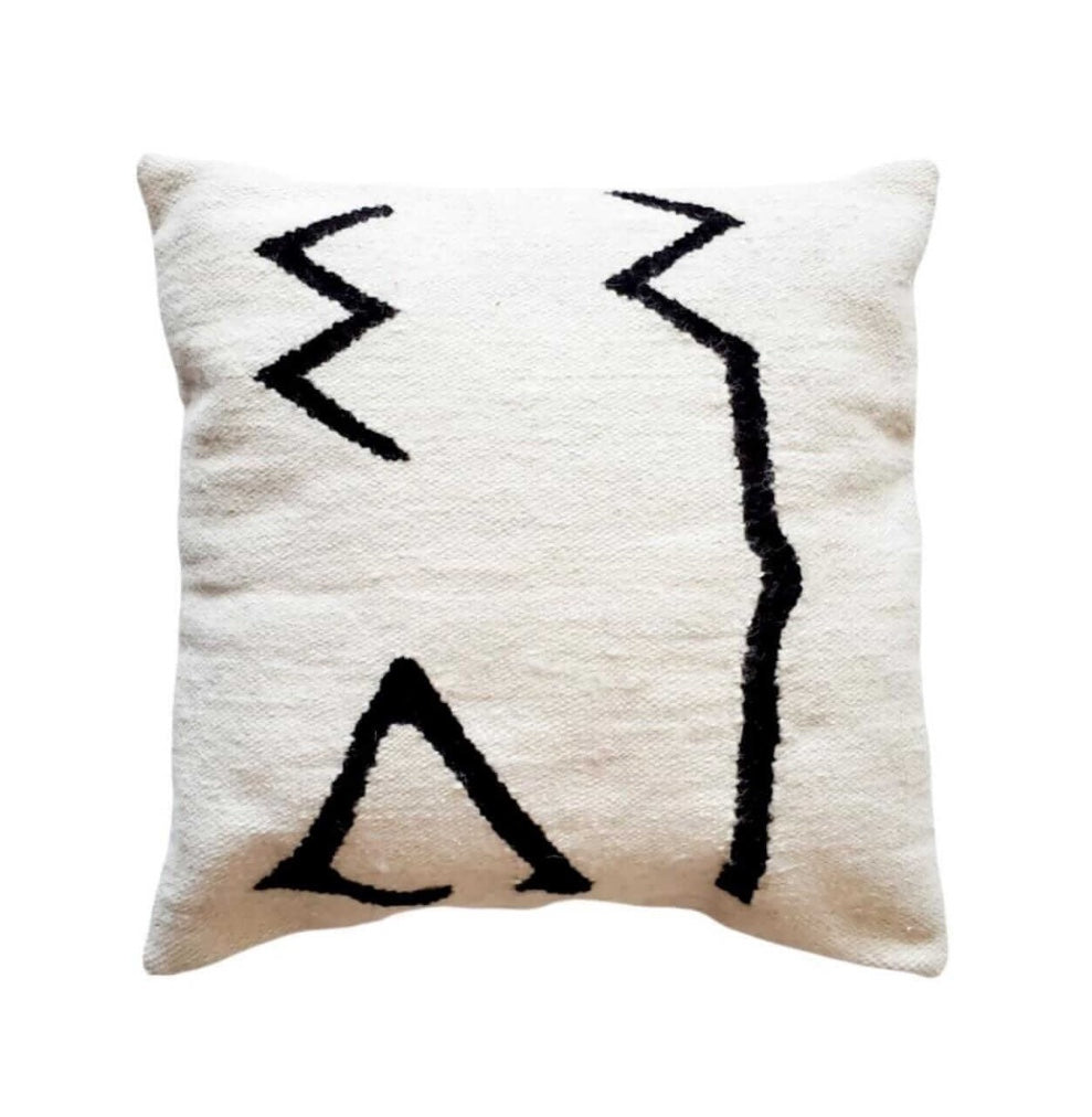 Decorative pillow with black abstract patterns on a white background